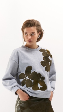 Knusse pull met groene accenten