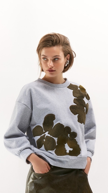 Knusse pull met groene accenten